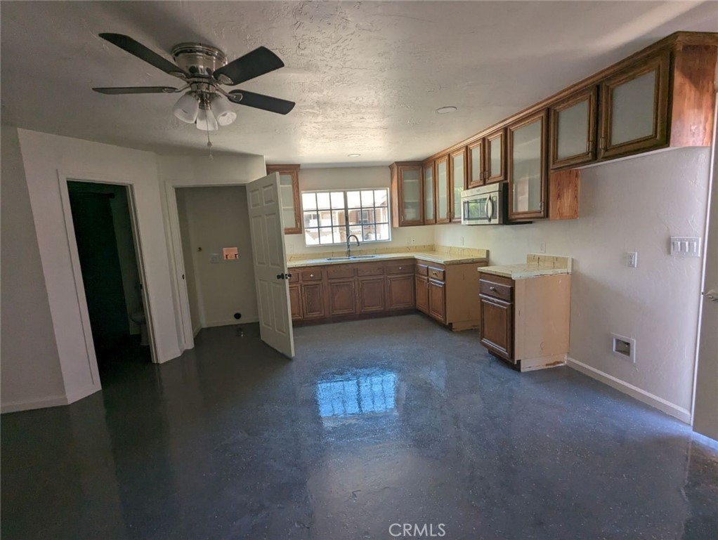 2886 Cridge Street Riverside, CA 92507 - Photo 11 of 21 a large kitchen with lot of cabinets and wooden floor