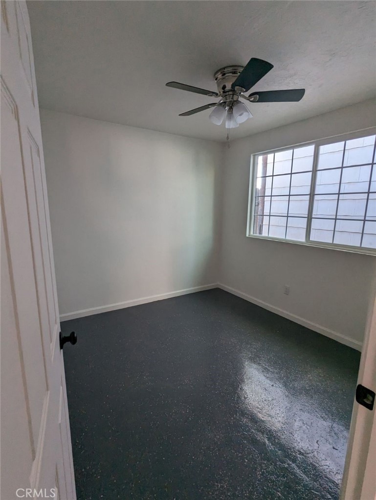 2886 Cridge Street Riverside, CA 92507 - Photo 13 of 21 an empty room with a ceiling fan and window
