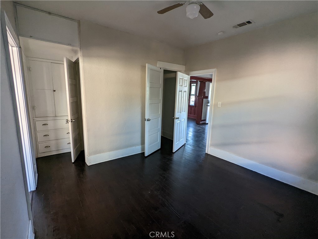 2886 Cridge Street Riverside, CA 92507 - Photo 4 of 21 an empty room with wooden floor and mirror