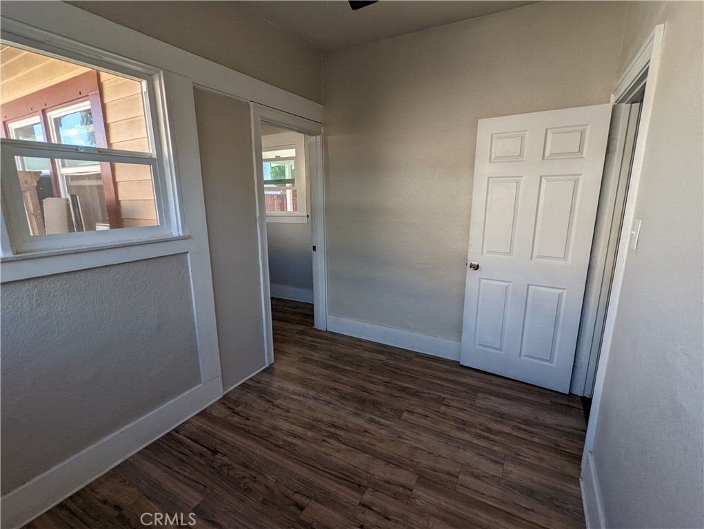 2886 Cridge Street Riverside, CA 92507 - Photo 5 of 21 an empty room with wooden floor and windows