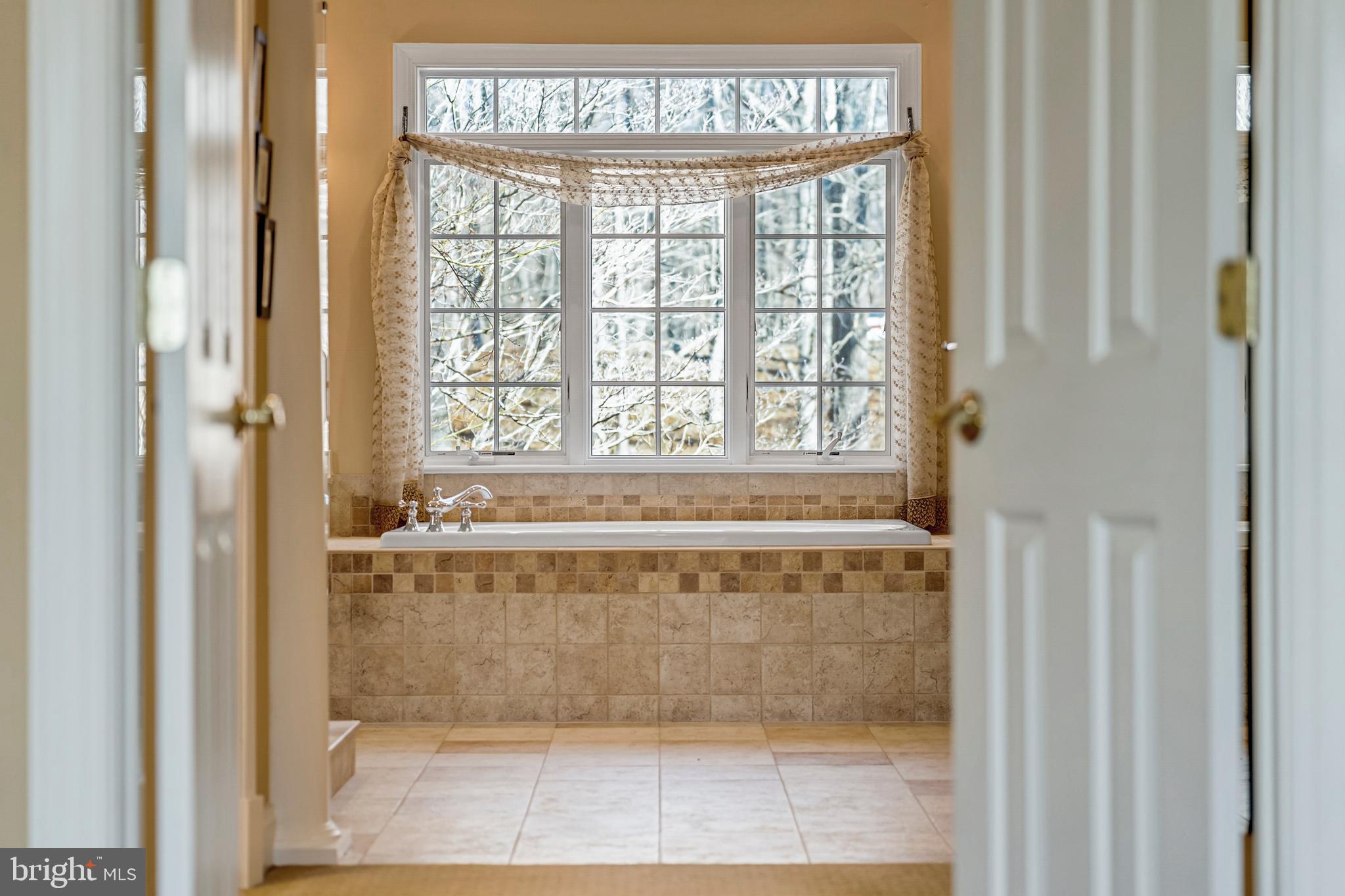 8986 Woodward Road Marshall, VA 20115 - Photo 23 of 45 a bathroom with a bathtub and a shower
