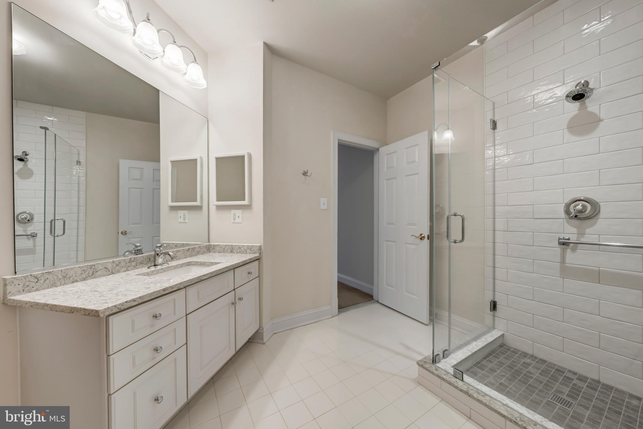 8986 Woodward Road Marshall, VA 20115 - Photo 30 of 45 a spacious bathroom with a granite countertop sink mirror and shower