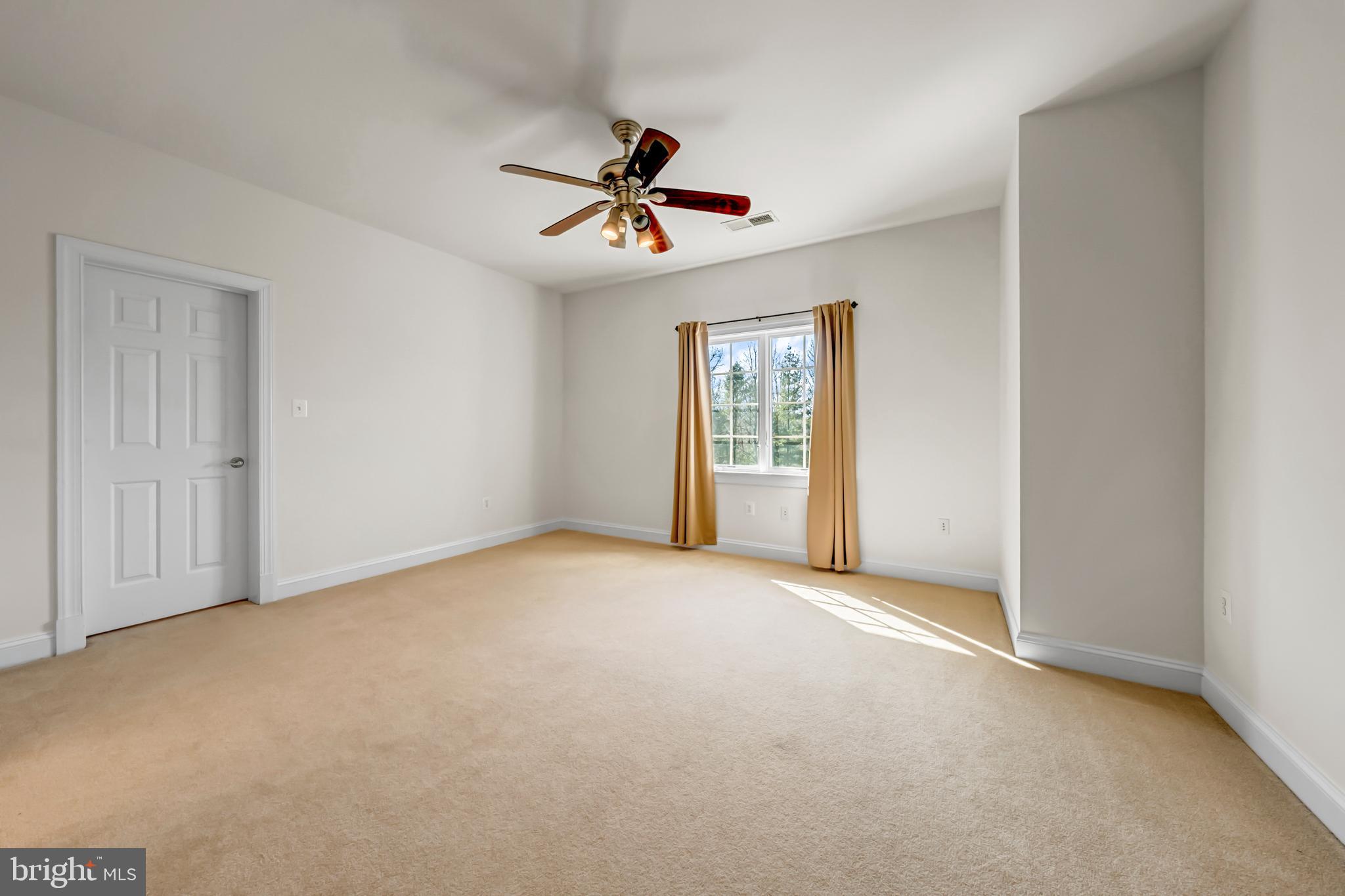 8986 Woodward Road Marshall, VA 20115 - Photo 31 of 45 an empty room with windows and fan