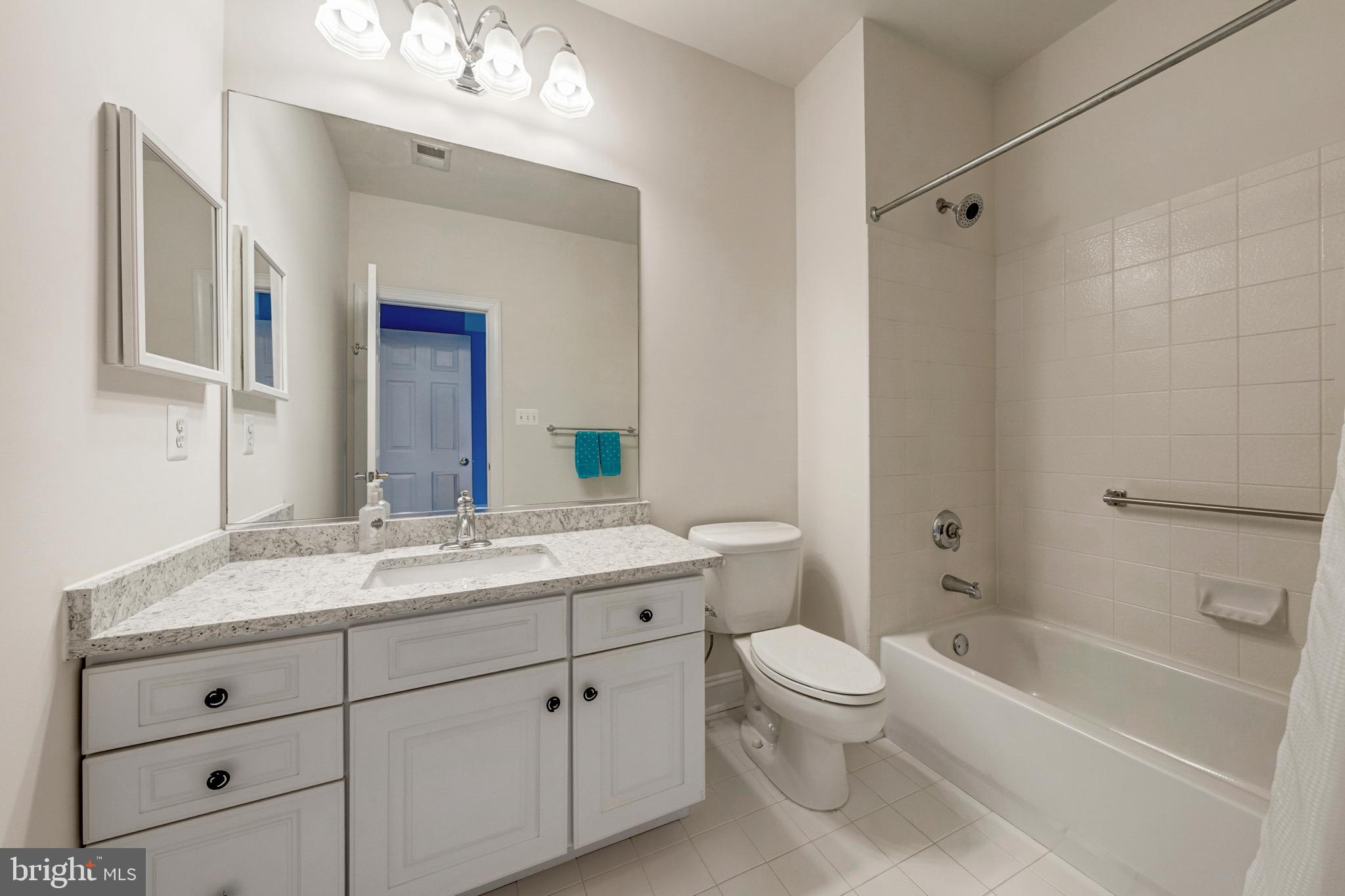 8986 Woodward Road Marshall, VA 20115 - Photo 34 of 45 a bathroom with a granite countertop sink a toilet and a bathtub