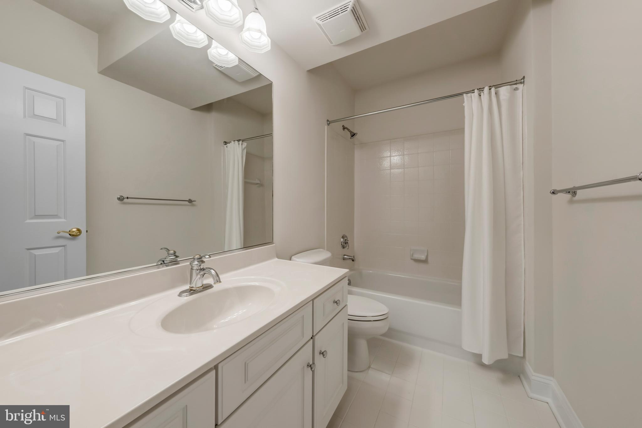 8986 Woodward Road Marshall, VA 20115 - Photo 38 of 45 a bathroom with a double vanity sink toilet and shower