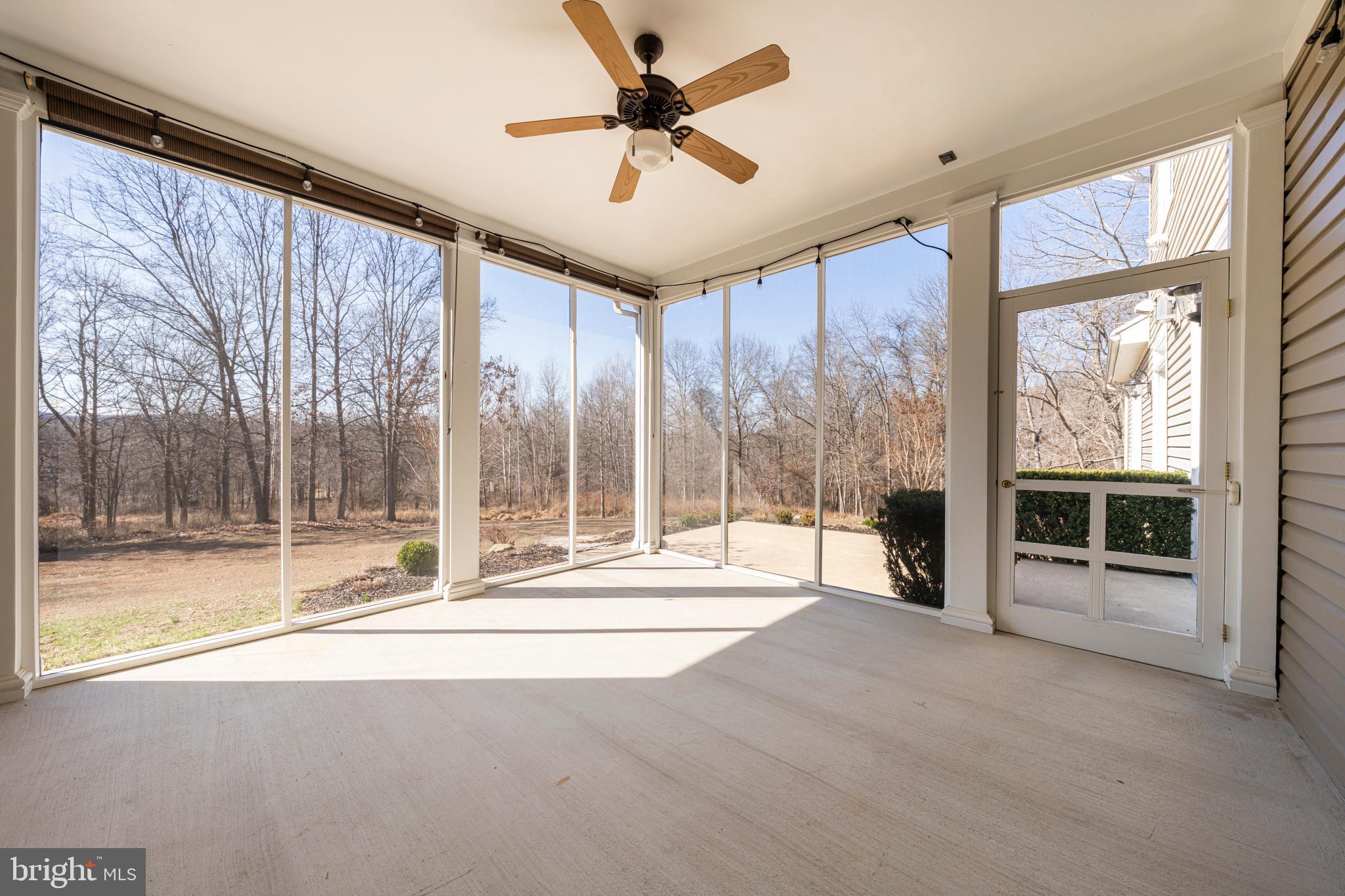 8986 Woodward Road Marshall, VA 20115 - Photo 40 of 45 a living room with a large window and a ceiling fan