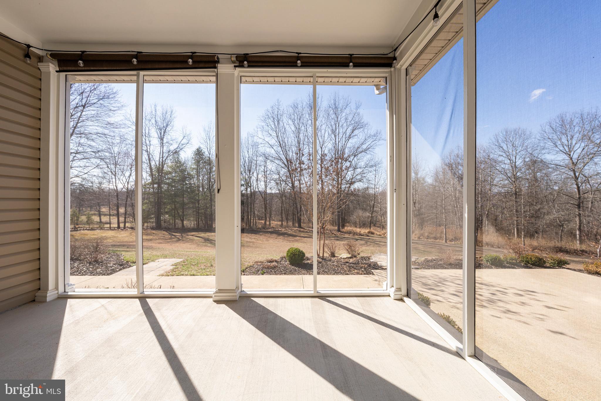 8986 Woodward Road Marshall, VA 20115 - Photo 41 of 45 a view of a glass door and porch with a yard
