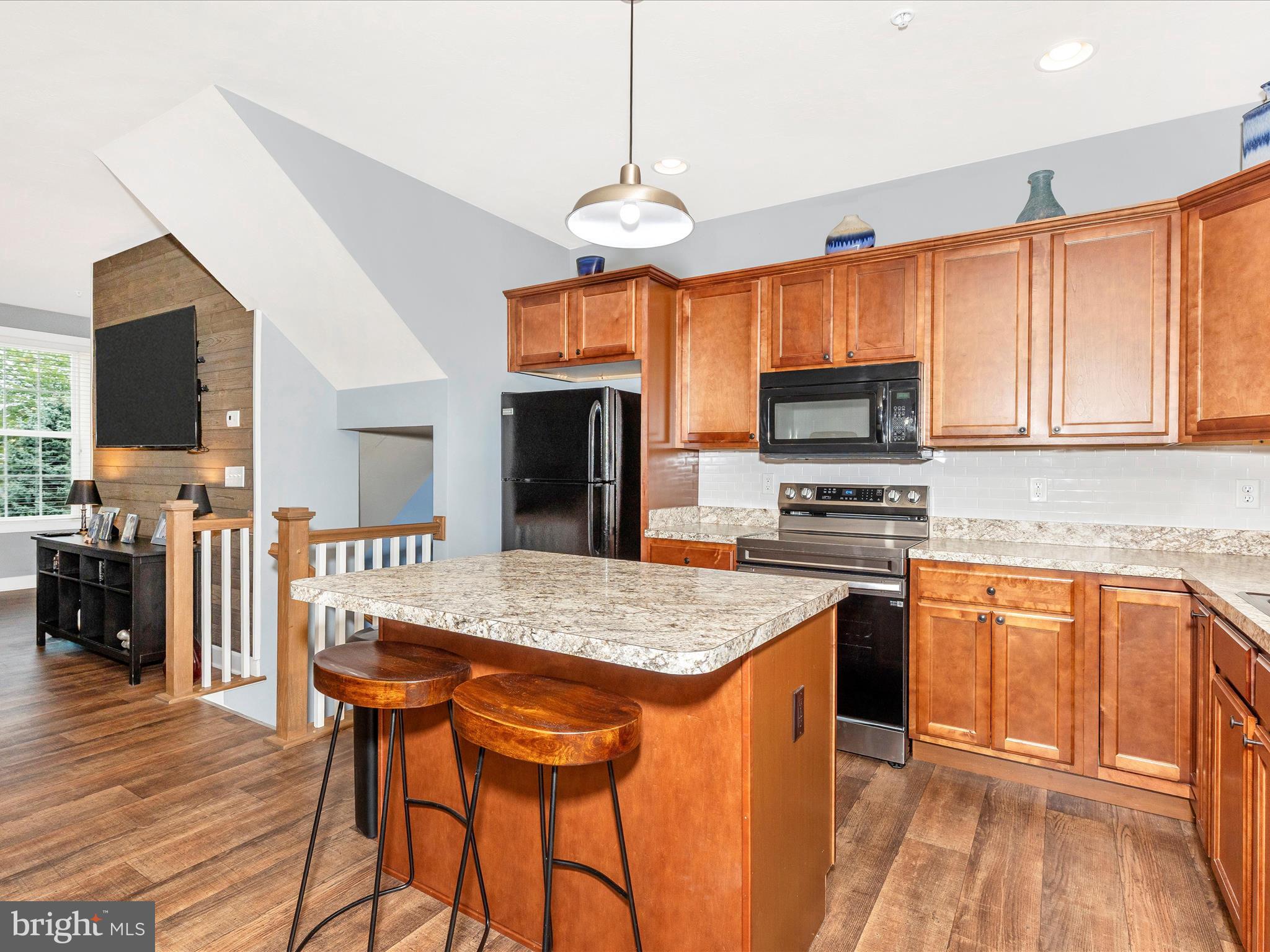 28 Brookside Avenue Hanover, PA 17331 - Photo 30 of 51 a kitchen with stainless steel appliances granite countertop a stove top oven a sink dishwasher and a refrigerator with wooden floor