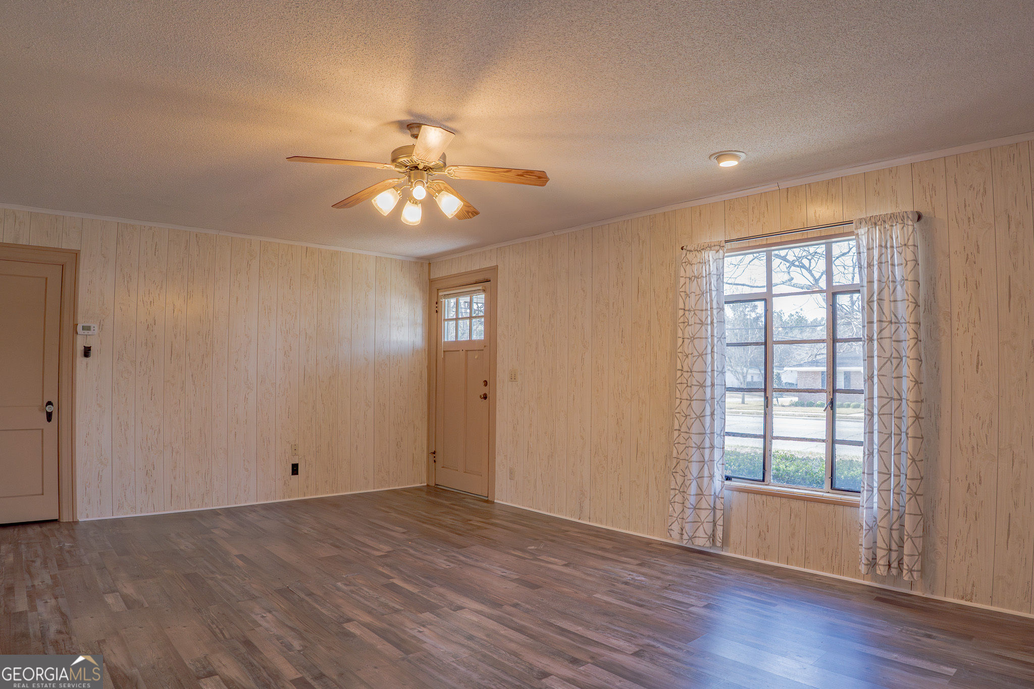 1615 Brunel Street Waycross, GA 31501 - Photo 3 of 28 a view of empty room with wooden floor and fan
