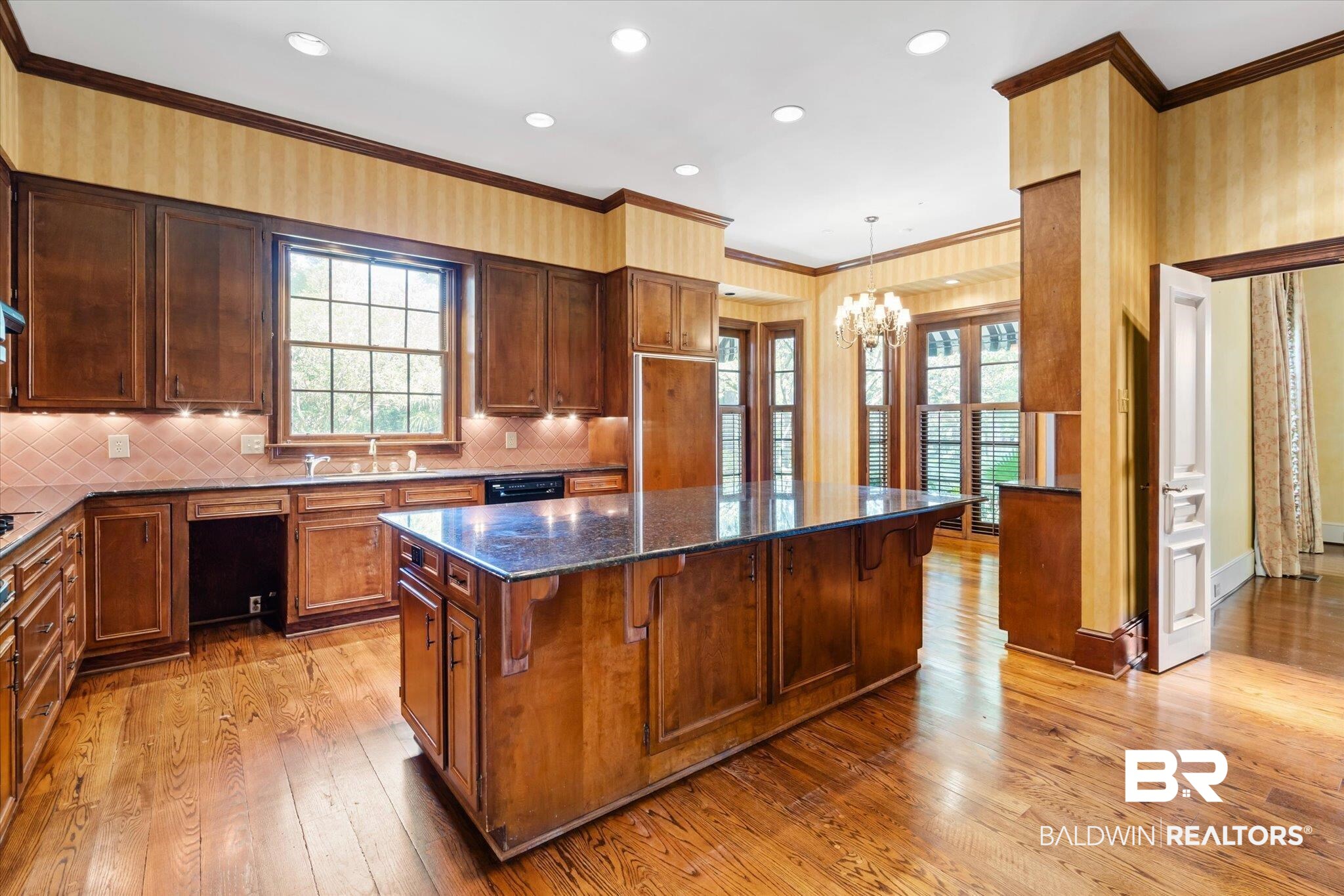 54 Turnin Lane Mobile, AL 36608 - Photo 11 of 35 Kitchen featuring a kitchen island, dark stone countertops, plenty of natural light, and light hardwood / wood-style flooring