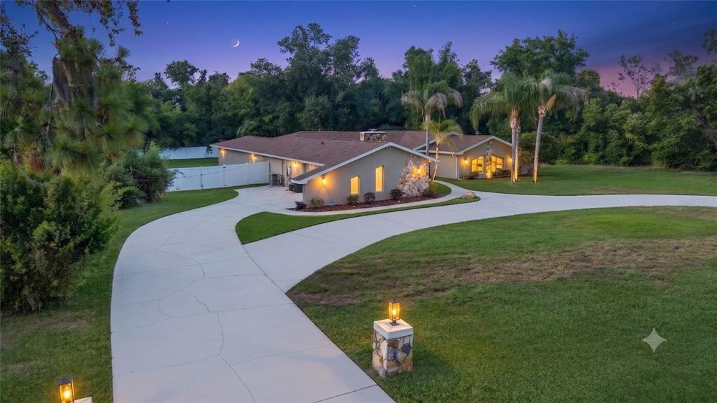 7487 River Country Drive Weeki Wachee, FL 34607 - Photo 2 of 53 a view of a house with a big yard