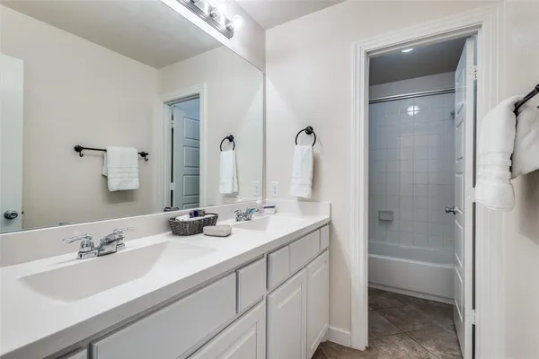 a bathroom with double sink and a mirror