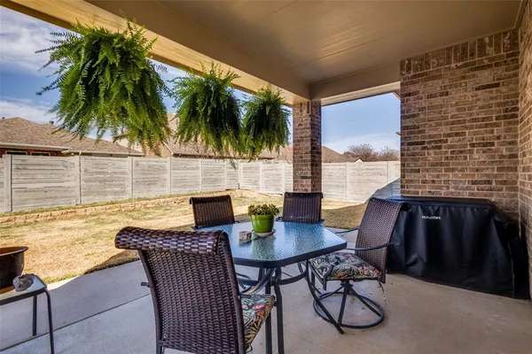 a view of a patio with a table and chairs