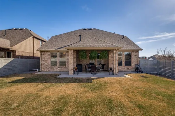 a view of a house with backyard porch and sitting area