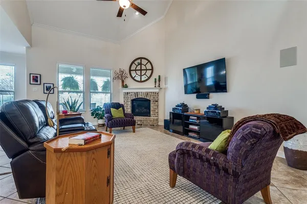 a living room with furniture a fireplace and a flat screen tv