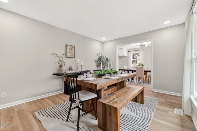 a view of a workspace with furniture and wooden floor