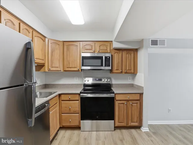 a kitchen with a sink stove and refrigerator