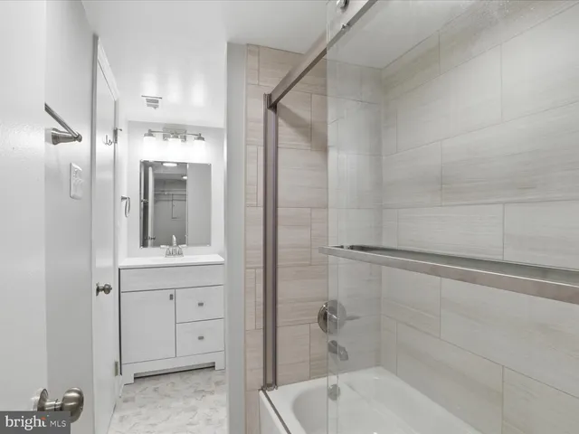 a bathroom with a bathtub and a sink