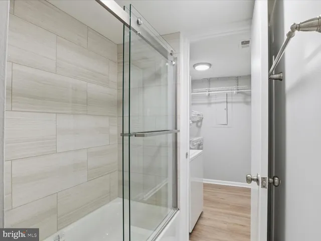 a bathroom with a glass shower door