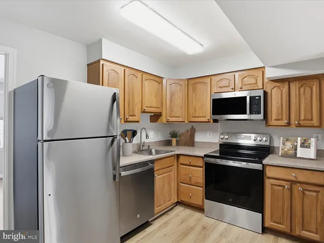 a kitchen with a refrigerator sink and microwave