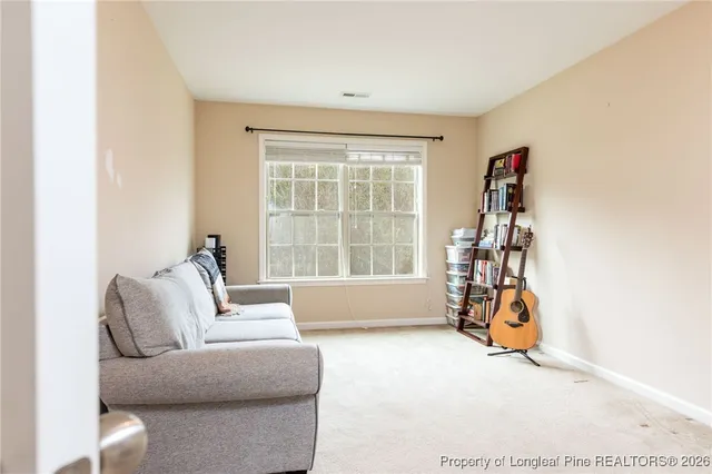 a living room with furniture a window and a chandelier