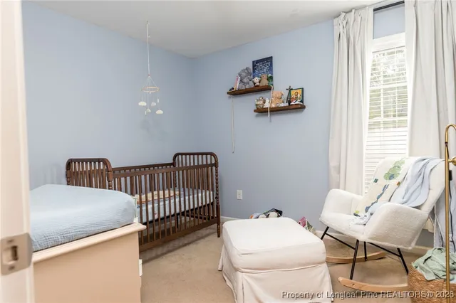 a large bed sitting in a bedroom next to a window