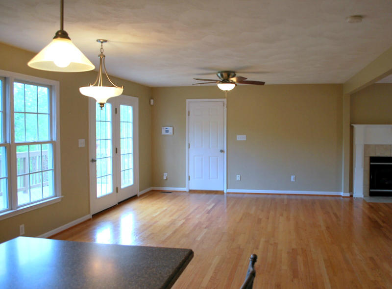 142 Piper Glenn Blue Ridge, VA 24064 - Photo 8 of 46 an empty room with wooden floor chandelier and windows
