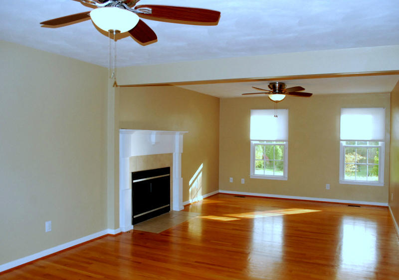142 Piper Glenn Blue Ridge, VA 24064 - Photo 9 of 46 an empty room with wooden floor a fireplace and windows