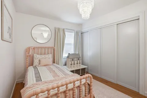 a view of a patio with a table and chairs under an umbrella