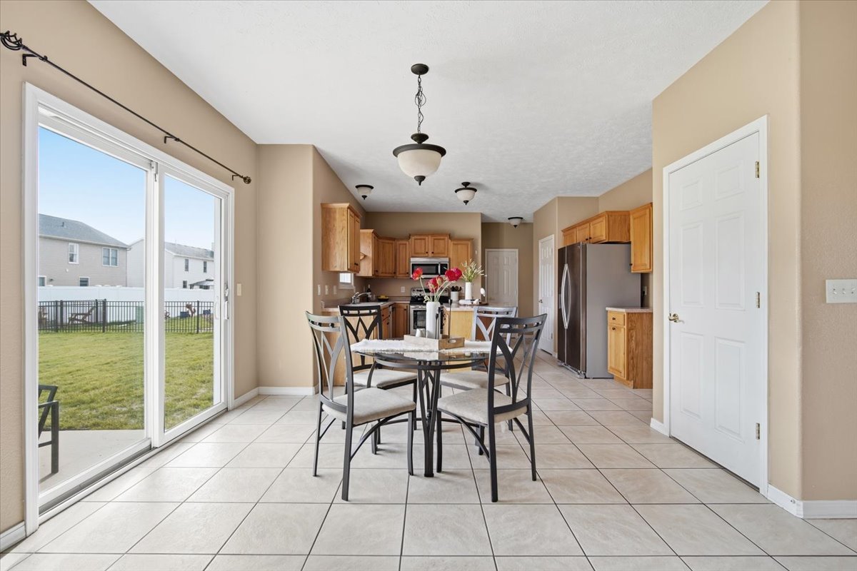 3255 Fire Fly Court Normal, IL 61761 - Photo 6 of 25 a view of a dining room with furniture and a chandelier