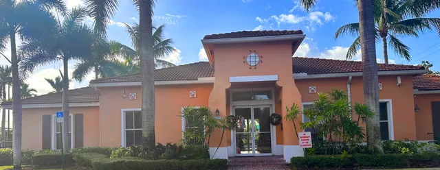 a house that has a palm tree in front of it
