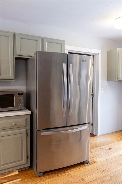 20 Paige Hill Road Brimfield, MA 01010 - Photo 18 of 40 a view of a refrigerator in kitchen and an empty room with wooden floor