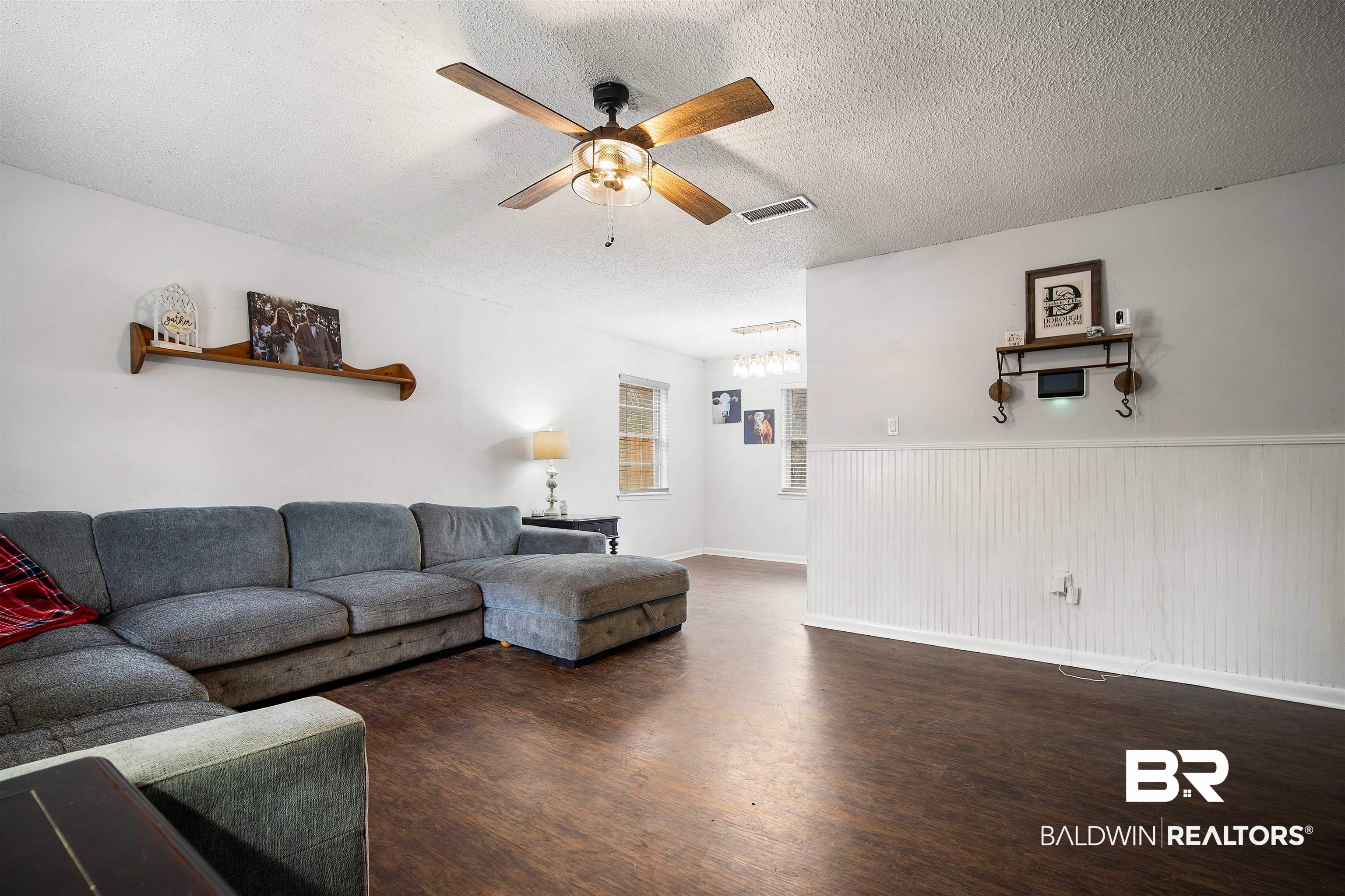 5110 Wilmer Road Wilmer, AL 36587 - Photo 5 of 24 Living room featuring a textured ceiling, dark hardwood / wood-style floors, and ceiling fan