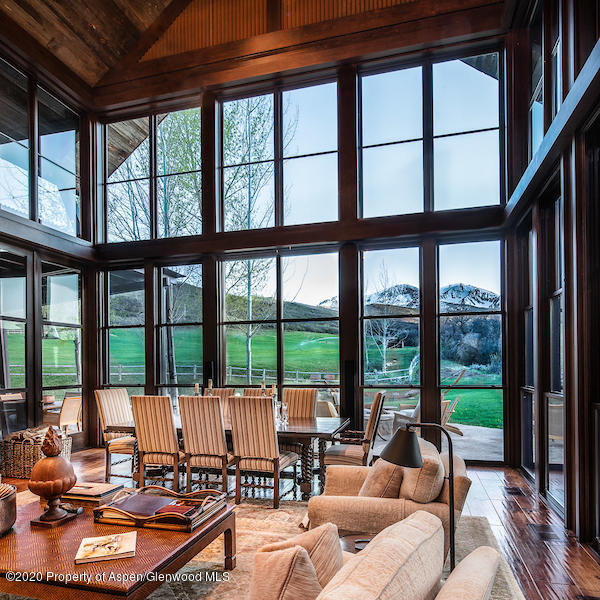 a living room with furniture and floor to ceiling windows