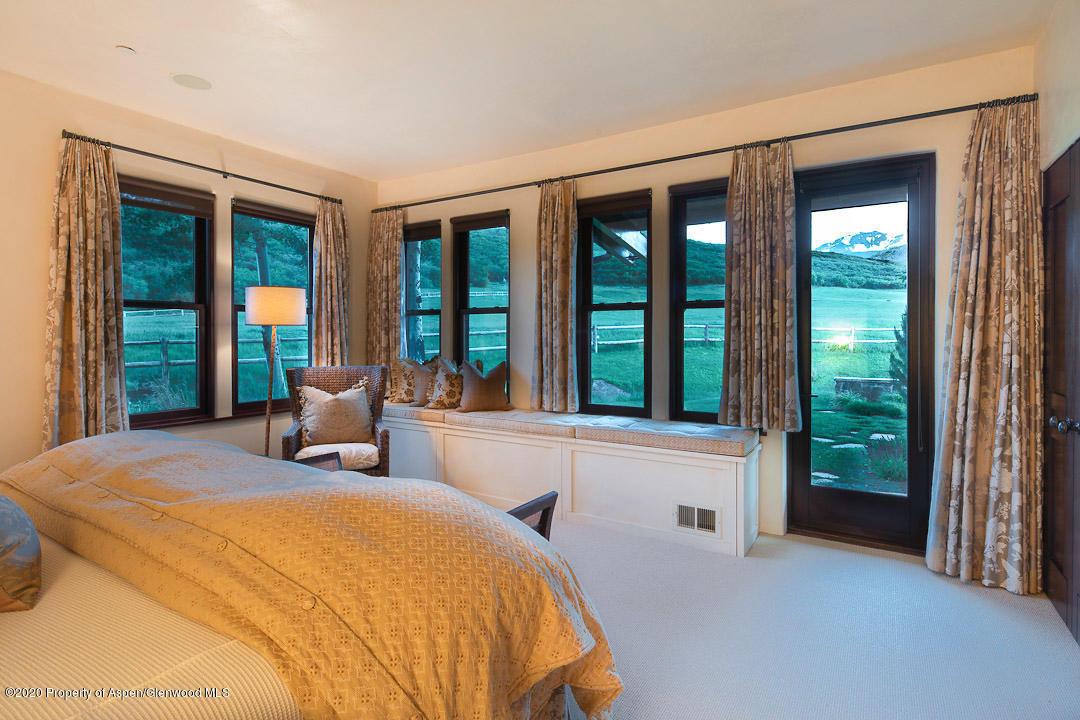 630 Spring Creek Road Basalt, CO 81621 - Photo 21 of 72 a spacious bedroom with a bed and a large window