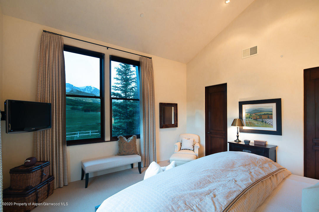 630 Spring Creek Road Basalt, CO 81621 - Photo 22 of 72 a bedroom with a bed and a flat screen tv
