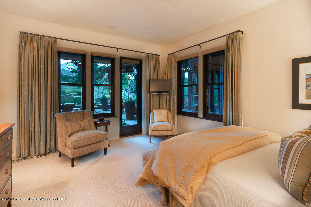 630 Spring Creek Road Basalt, CO 81621 - Photo 23 of 72 a bedroom with a bed couch and a large window
