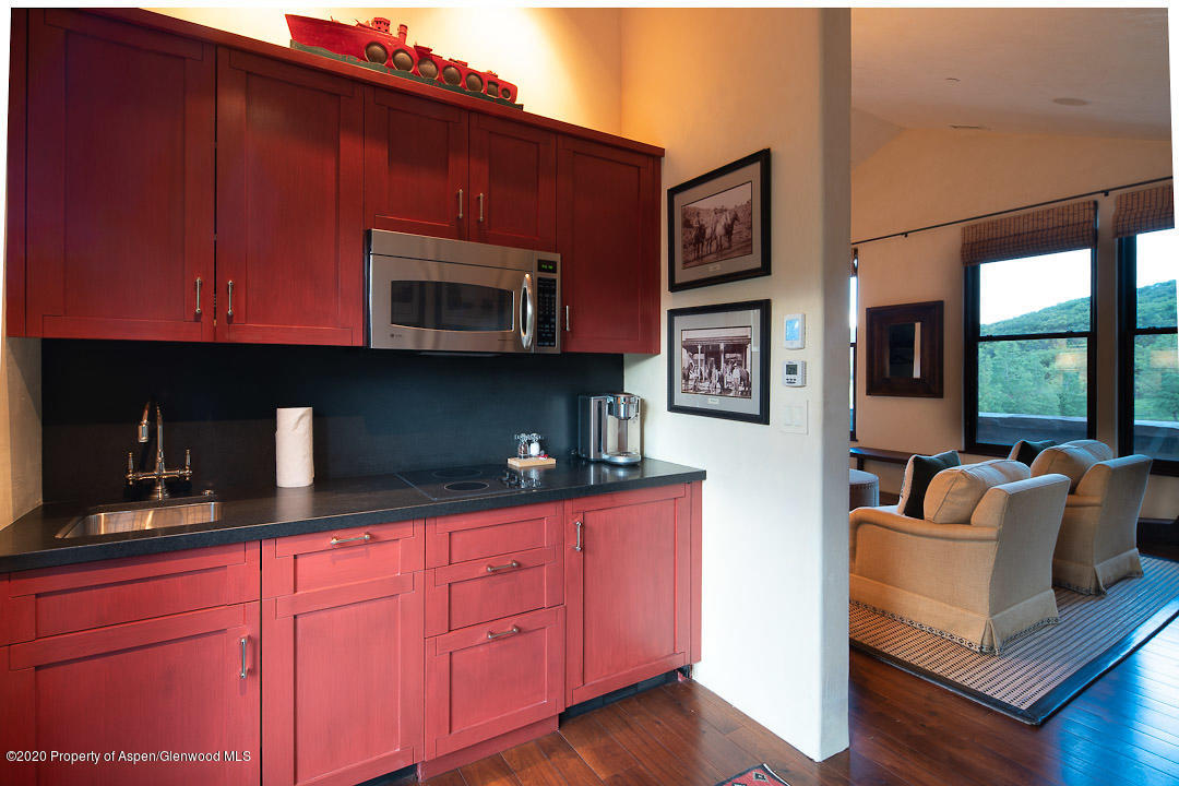 630 Spring Creek Road Basalt, CO 81621 - Photo 25 of 72 a kitchen with stainless steel appliances granite countertop a stove top oven a sink dishwasher and cabinets with wooden floor