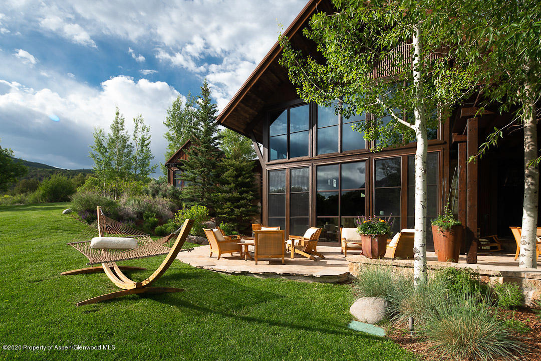 630 Spring Creek Road Basalt, CO 81621 - Photo 26 of 72 a view of a chair and table in backyard of the house