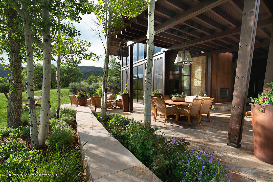 630 Spring Creek Road Basalt, CO 81621 - Photo 64 of 72 a view of a patio with table and chairs potted plants and floor to ceiling window