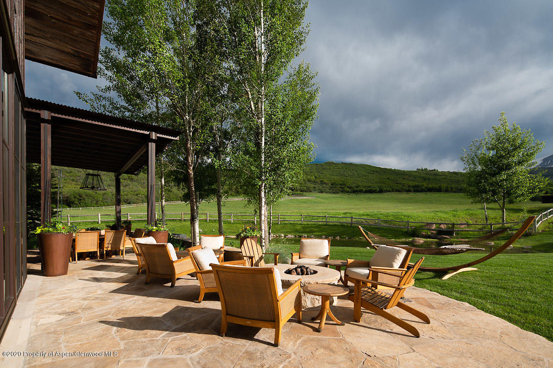 630 Spring Creek Road Basalt, CO 81621 - Photo 65 of 72 a view of a patio with couches potted plants and a big yard