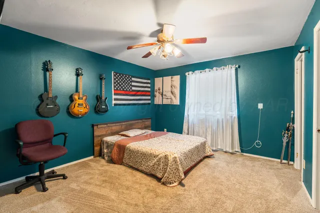 a bathroom with a toilet sink and shower curtain