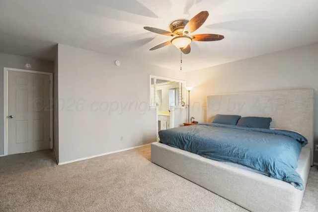a bathroom with a granite countertop sink a mirror and a bathtub