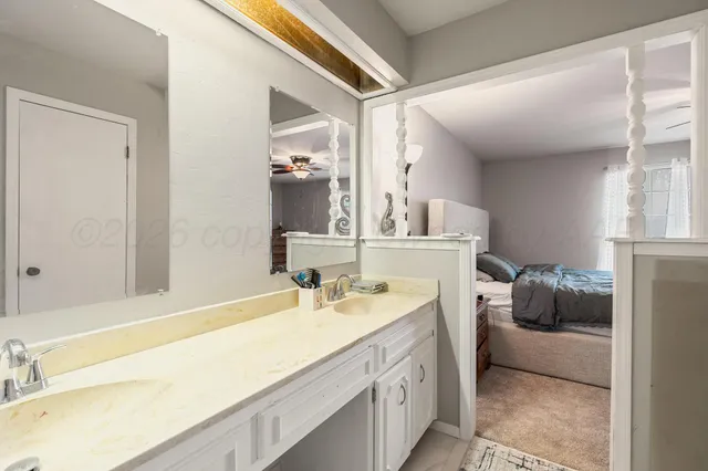 a view of a house with large space and a car park in front of it