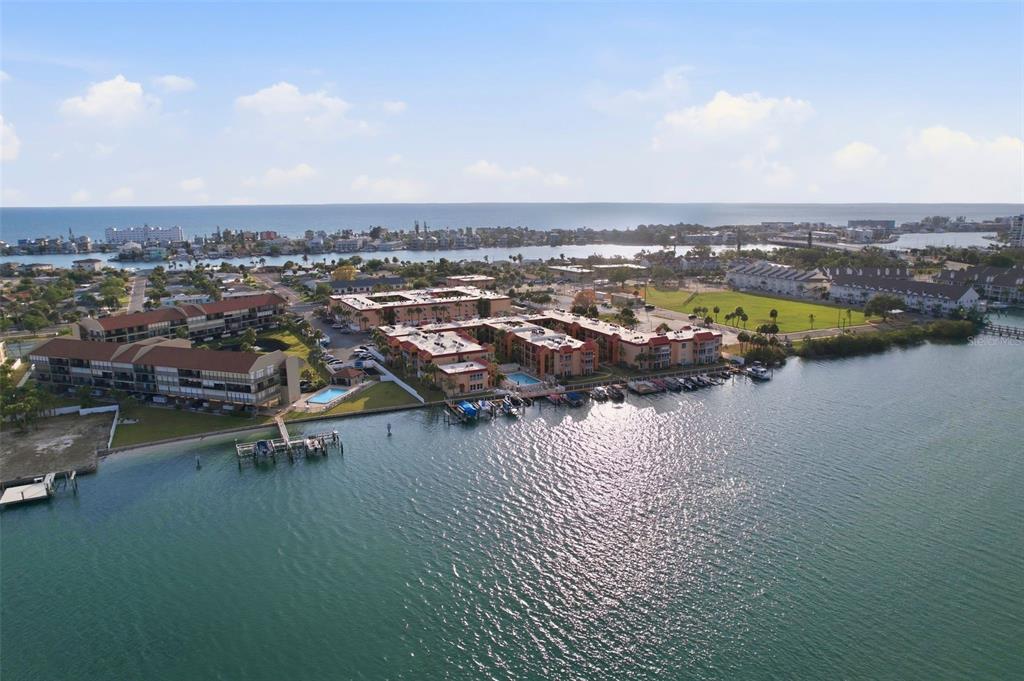 8921 Blind Pass Road, Unit 144 St. Pete Beach, FL 33706 - Photo 1 of 37 an aerial view of a city with lake view