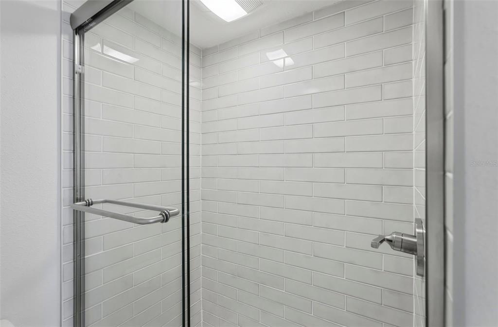 8921 Blind Pass Road, Unit 144 St. Pete Beach, FL 33706 - Photo 12 of 37 a bathroom with a shower