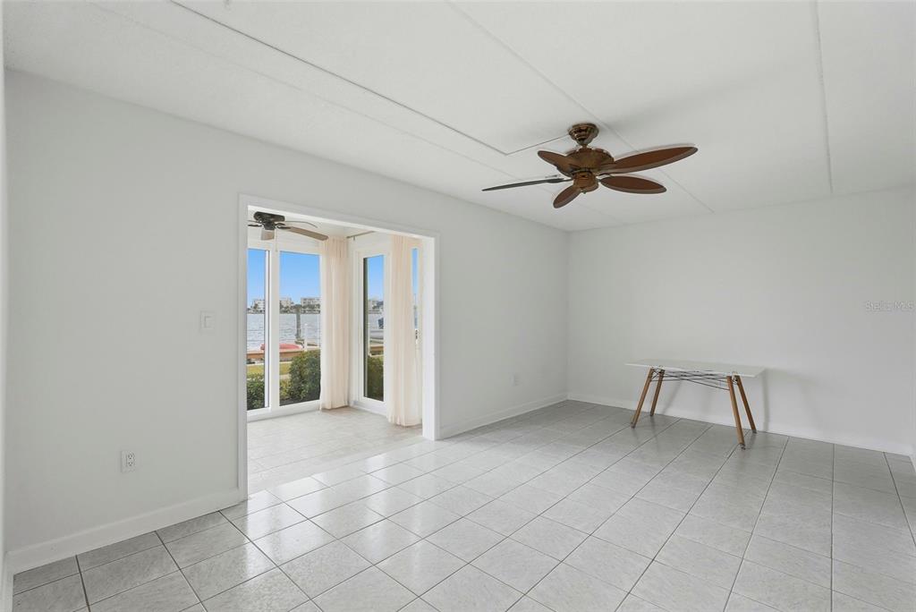 8921 Blind Pass Road, Unit 144 St. Pete Beach, FL 33706 - Photo 13 of 37 wooden floor in an empty room with a window