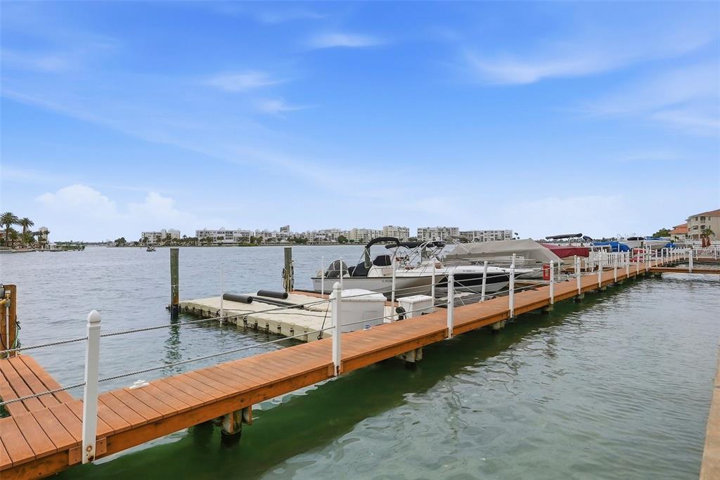 8921 Blind Pass Road, Unit 144 St. Pete Beach, FL 33706 - Photo 18 of 37 a view of a lake with tall buildings in the background