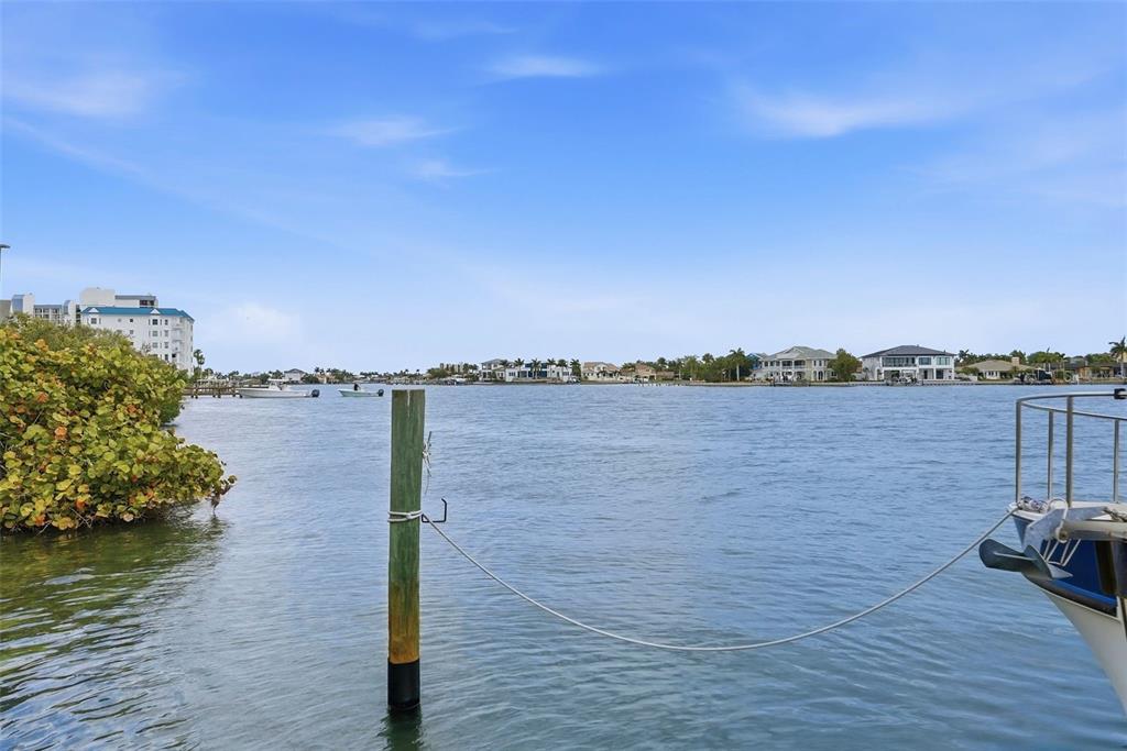8921 Blind Pass Road, Unit 144 St. Pete Beach, FL 33706 - Photo 22 of 37 a view of a lake with houses in the back