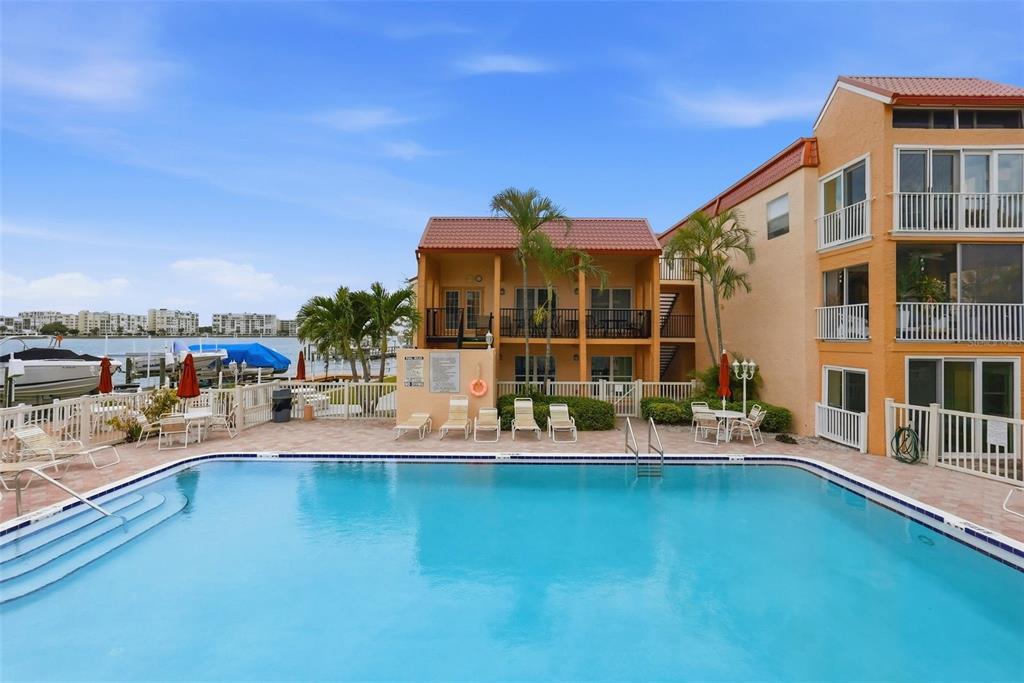 8921 Blind Pass Road, Unit 144 St. Pete Beach, FL 33706 - Photo 36 of 37 a view of houses with outdoor space and seating